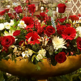 Large arrangement of red roses and white flowers in a gold bowl vase