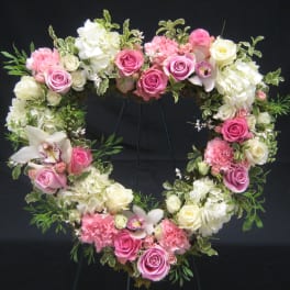 Heart-shaped floral wreath with pink and white roses and hydrangeas