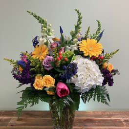 Colorful mixed flower arrangement in a glass vase