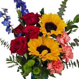 Bouquet of red roses, yellow sunflowers, and pink carnations