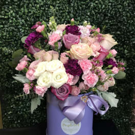 Pink and white rose bouquet in a lavender hat box with ribbon