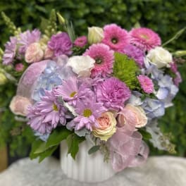 Pink and lavender bouquet with roses, daisies, and hydrangea in a white vase