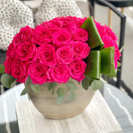 Hot pink rose bouquet in a round beige vase