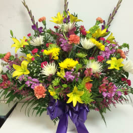 Colorful mixed bouquet in a vase with a purple ribbon
