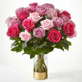 Bouquet of pink and lavender roses in a clear glass vase
