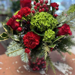 Red roses and carnations with green hydrangea in a vase