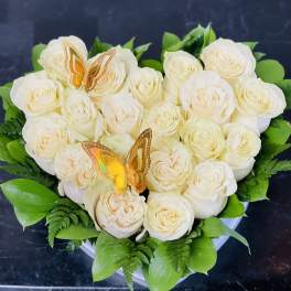 Heart-shaped bouquet of white roses with butterfly picks