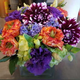 Colorful bouquet of dahlias and hydrangeas in a glass vase
