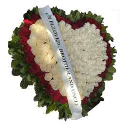 Heart-shaped rose wreath with a white memorial ribbon