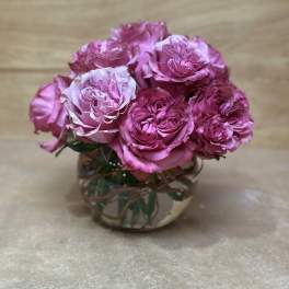 Pink roses arranged in a clear glass vase
