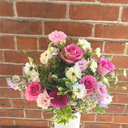 Pink and white mixed bouquet in a ribbed white vase