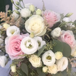 Bouquet of pink and white roses with small white blooms