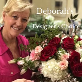 Woman holding a bouquet of red, pink, and white flowers
