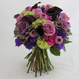 Bouquet of pink and purple flowers with dark calla lilies