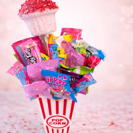 Candy bouquet in a popcorn container with a pink heart topper
