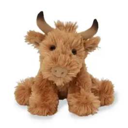 Plush brown cow toy with horns sitting on a white background