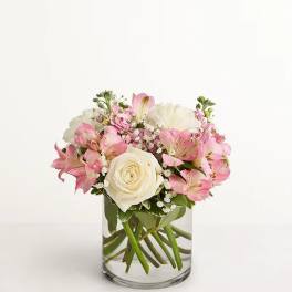 Pink and white bouquet in a clear glass vase