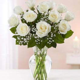 White roses arranged in a clear glass vase