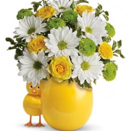 Yellow vase with daisies and roses, plus a small chick figurine