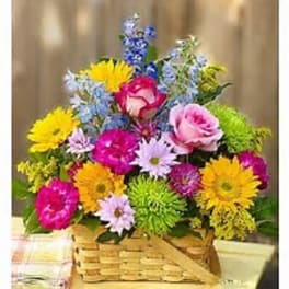 Colorful mixed bouquet in a wicker basket