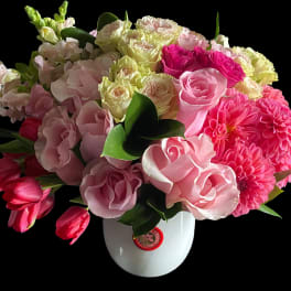 Pink and white mixed bouquet in a white vase