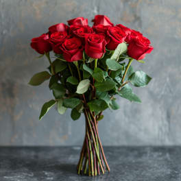 Bouquet of red roses with green leaves