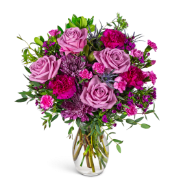 Pink and purple mixed bouquet in a clear glass vase