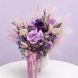 Lavender and pink floral arrangement in a white vase