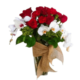 Red roses and white orchids in a glass vase with a burlap bow