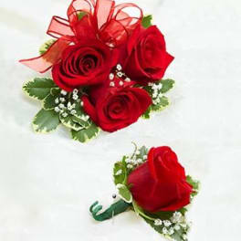 Red rose boutonniere and matching mini bouquet on white background