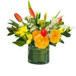 Yellow and orange flowers arranged in a clear glass vase