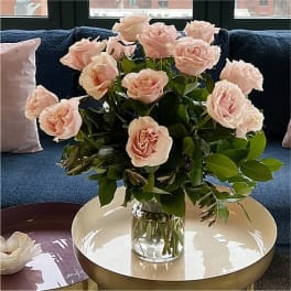 Bouquet of pale pink roses in a clear glass vase