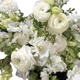 White floral bouquet with green accents and layered blooms