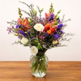Colorful mixed bouquet in a clear glass vase