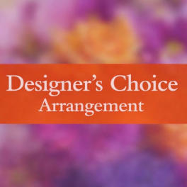 Designer’s Choice Arrangement sign over a blurred floral background