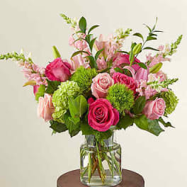 Pink and green mixed bouquet in a clear glass vase