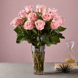Pink roses arranged in a clear glass vase