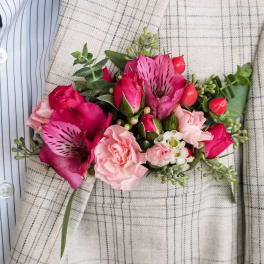Pink and red floral corsage with roses and alstroemeria
