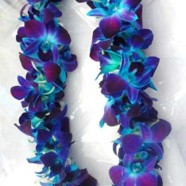 Purple and blue flower lei on white fabric