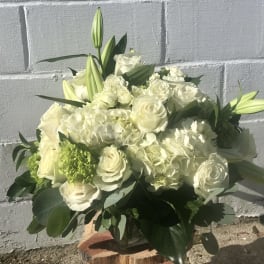 White roses and lilies arranged in a low bouquet
