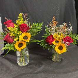 Two small vase arrangements with red roses and sunflowers