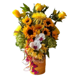 Yellow and orange floral arrangement with orchids in a wrapped vase