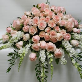 Large arrangement of pale pink roses with white trailing flowers