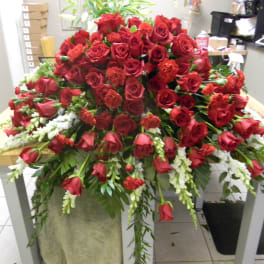 Large arrangement of red roses with white accents on a table