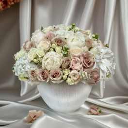 Blush and white rose bouquet in a white vase