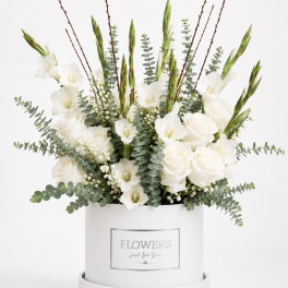 White roses and gladiolus in a white hatbox with eucalyptus