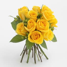 Bouquet of yellow roses with green berries and leaves