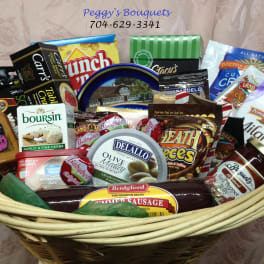 Gift basket filled with assorted packaged snacks and condiments