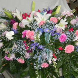 Large mixed floral arrangement with lilies, carnations, and roses