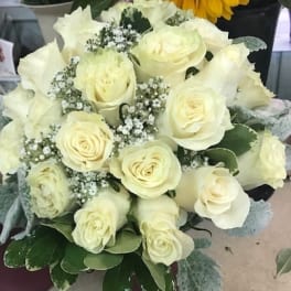 Bouquet of white roses with baby's breath and greenery